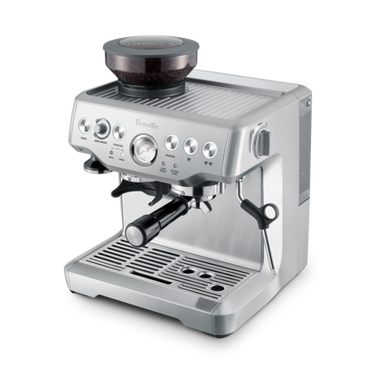 The Breville - The Barista Express™ espresso machine, with built-in grinder, digital display, pressure gauge, and steam wand, is displayed in stainless steel against a white background.