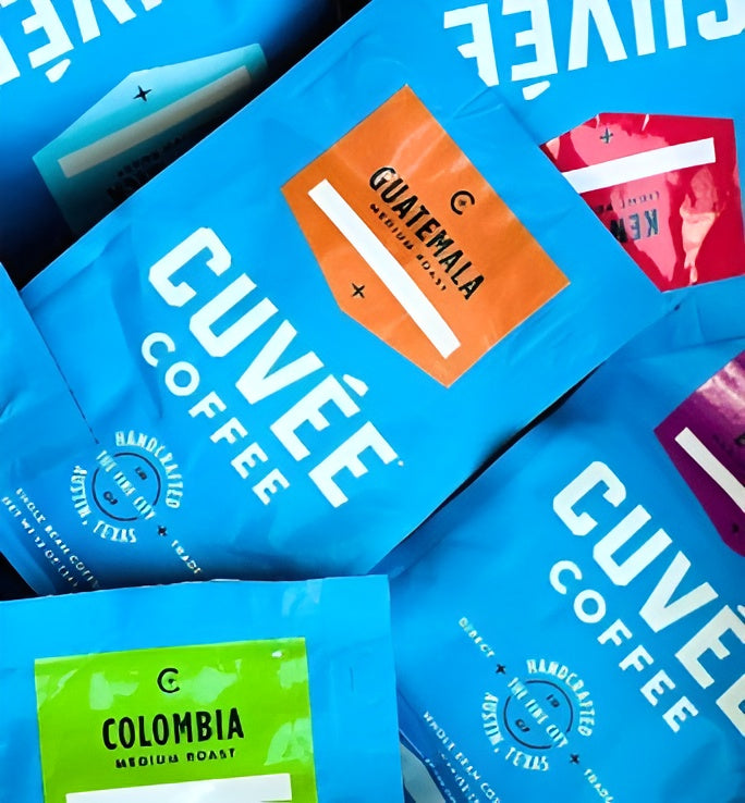 Multiple packages of Cuvee Coffee in various flavors and colors.